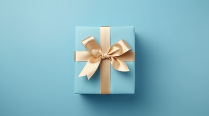 A nice gift box decorated craft papper with a bow on blue background. New Year, Christmas, birthday, Valentines Day, World Womans Day, Fathers Day. top view