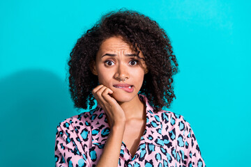 Photo of worried girl wear trendy leopard print clothes hand touch face bite lips oops problem trouble isolated on cyan color background