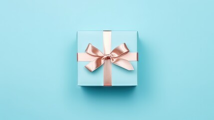 A nice gift box decorated craft papper with a bow on blue background. New Year, Christmas, birthday, Valentines Day, World Womans Day, Fathers Day. top view