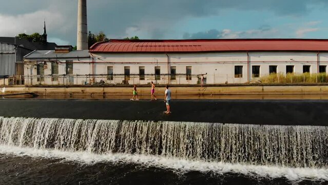A drone view of a young guy standing on the dam of the Jizera River in the Czech Republic. Dam on the Jizera River in the Czech Republic. Village in Semilsky district of Liberec region