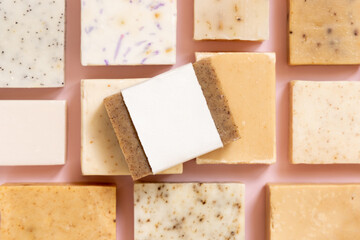 Beige and brown handmade soap bars on light pink top view, soap packaging mockup