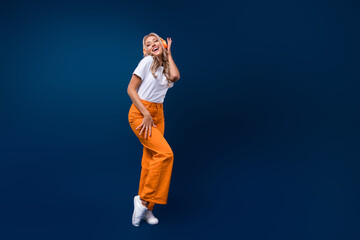 Full length photo of crazy glad girl wear trendy clothes listen hit wireless device empty space...