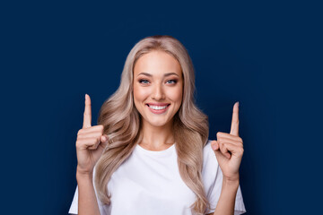 Photo of gorgeous cheerful girl in trendy clothes two arms direct empty space isolated on dark blue color background