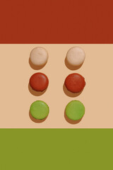 french dessert macarons, different colors on striped textureless background, top view, no people
