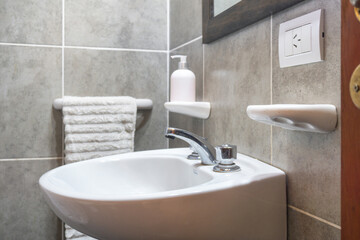 Fototapeta na wymiar Bathroom interior with sink and faucet