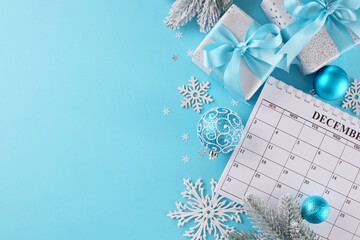 Get ready to share warmth and joy through meaningful holiday gifts. Top view shot of calendar, frosty fir twigs, beautiful presents, xmas decor, snowflakes, stars on blue background with advert space