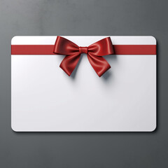 Blank minimal white gift card with red ribbon bow isolated on grey background