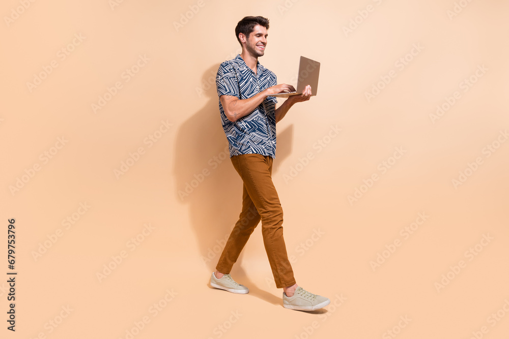 Aufkleber Full body length photo of happy young guy professional programming code working remotely using netbook isolated on beige color background