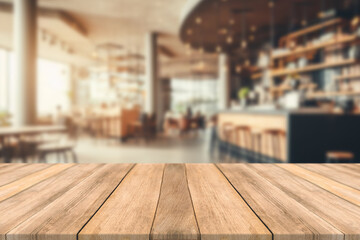 Empty wooden table space platform and blurred restaurant or coffee shop background for product...
