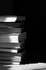 stack of books with abstract shadows in black and white mode
