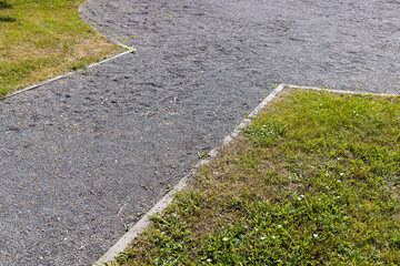 Obraz premium part of a walkway sprinkled with small rubble and stonesecological-style park path for walking