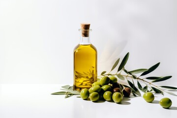 Bottle of natural extra virgin olive oil and green olives with leaves branch