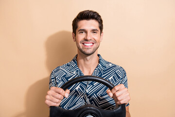 Photo of optimistic man with stylish hairdo dressed print shirt hold streering wheel at driving...