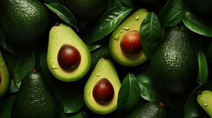 Foto op Plexiglas  a pile of avocados with leaves and drops of water on them and one of them has an avocado cut in half. © Shanti