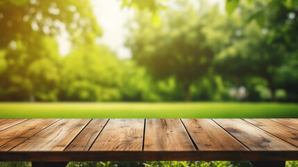 Wooden table and blurred green nature garden background. - obrazy, fototapety, plakaty