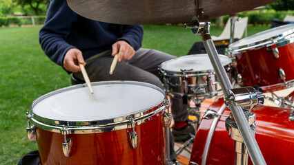 Close-up view of hands playing the drums.