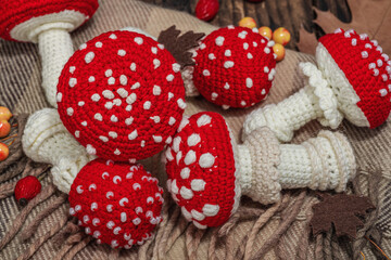 Autumn cozy mood composition. Crocheted amanita mushroom, handmade, fall hobby concept