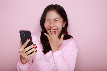 Asian woman cheerfully posing with a mobile, A beautiful young woman is feeling cheerful and...