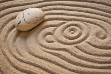 Zen sand garden meditation stone background. Balanced Stones and lines drawing in sand for relaxation. Concept of harmony, balance and meditation, spa, massage, relax.
