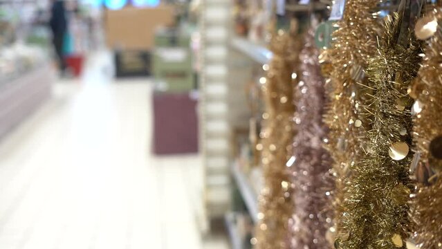 Colorful golden Christmas Garland rain Decorations in the shopping mall. New Year decor in the store