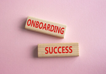 Onboarding Success symbol. Concept word Onboarding Success on wooden blocks. Beautiful pink...