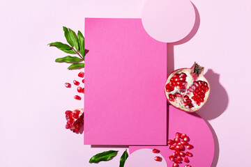 Top view cosmetic background for product presentation with pomegranate extract. Empty Cosmetic circle and square podiums and pomegranate extract on light pink background. Flat lay