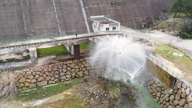 Drone video of the relief valve at the base of a gravity dam operating at full capacity of a dam.