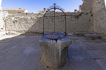 Image of a historic stone fountain in a medieval town