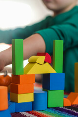 Toys colorful geometric shapes on educational games on bright mat made of fabric threads and child...