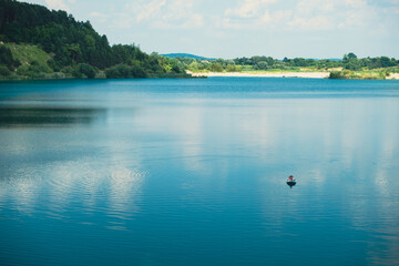 happy man lays down on supboard sunbathing