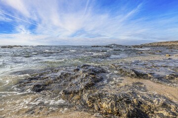 View of the turbulent Atlantic Ocean at Praia Aivados in Portugal in the morning light