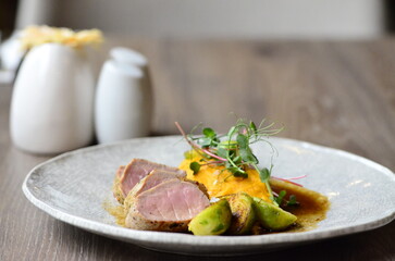 roasted pork loin with brussels sprouts and sauce, serving food