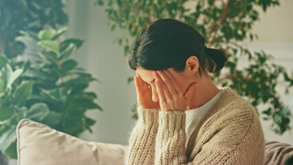 Depressed unhappy stressed woman. Closes her eyes and suffers from headaches, painful sensations,...