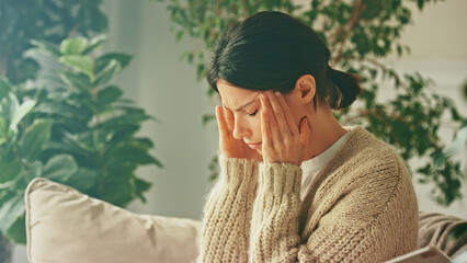 Depressed unhappy stressed woman. Closes her eyes and suffers from headaches, painful sensations,...