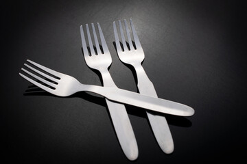 fork and knife on black