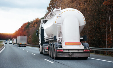Petrol cargo truck driving on highway hauling oil products. Fuel delivery transportation. Aviation...