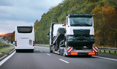A side view of the towing truck with a brand-new commercial vehicle for cargo shipping. Emergency...