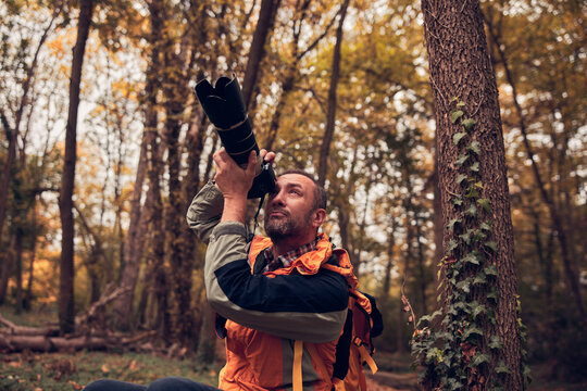 Man using camera for bird and animal photographing in nature.