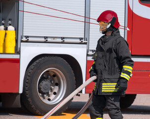 firefighter with helmet and fire truck on background
