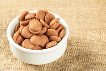 White porcelain cup with chocolate granules close-up