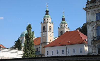 Fototapeta na wymiar bell towers with a dome with copper roofing of Church St. Nicholas of the city of Ljubljana the capital of Slovenia in central Europe