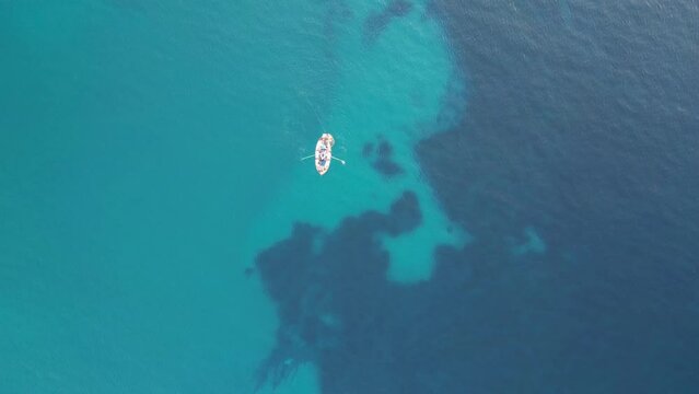 Fishing boat at sea while fishing, view from drone.