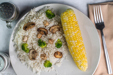 rice top  with broccoli mushrooms and  chicken,