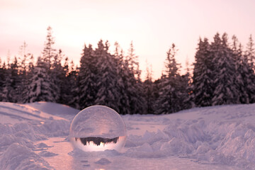3D rendering of glass ball buried in snow
