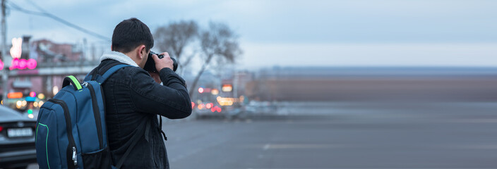 traveler man holding camera in street