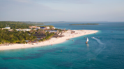 Aerial view of Zanzibar beach where tourists and locals mix together of colors and joy, concept of summer vacation, aerial view of Kendwa beach, Tanzania