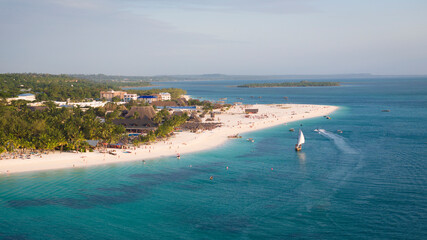 Aerial view of Zanzibar beach where tourists and locals mix together of colors and joy, concept of...