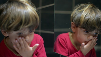 Bedtime Gaze - Little Boy in Pajamas Observing His Reflection at Night