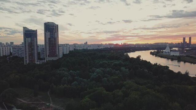 A green district of city with parks, river and high-rise residential buildings.