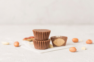 Tasty chocolate peanut butter cups on concrete background